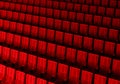 Rows of red velvet seats watching movies in the cinema with copy space banner background. Entertainment and Theater concept. 3D Royalty Free Stock Photo