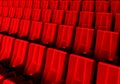 Rows of red velvet seats watching movies in the cinema with copy space banner background. Entertainment and Theater concept. 3D Royalty Free Stock Photo