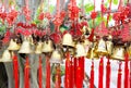 Rows of red wind bells golden buddhist prosperity bell at chinese temple people wish and hang them Royalty Free Stock Photo