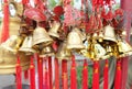 Rows of red wind bells golden buddhist prosperity bell at chinese temple people wish and hang them Royalty Free Stock Photo