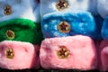 Rows of russian winter hats of different colors with army emblems at the street market at Old Arbat street