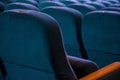 Rows of seats in the auditorium in the cinema, soft seat backs, empty room, before the event. chairs cinema