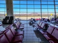 Rows of seats in the departure area of Esenboga Airport against the backdrop of mountain Royalty Free Stock Photo