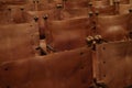 Leather chairs. Rows of vintage brown leather seats inside a conference room with metal knobs.