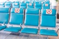 Rows seats in the waiting room with a sign applied- do not occupy, do not sit down. Social distance concept, pandemic precautions