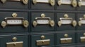 Rows of Secure Dark Gray Safety Deposit Boxes with Ornate Brass Handles in a Vault Room Setting Royalty Free Stock Photo