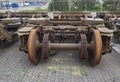 Rows of separated cast metal Train bogies which are being recycled, on the ground at the Amsterdam Container Terminal.