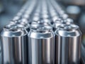 Rows of shiny silver metal cans aligned in a factory production line ready for packaging with a focus on the front three empty Royalty Free Stock Photo
