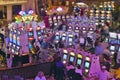 Rows of slot machines and gamblers at Rio Casino in Las Vegas, NV