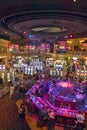 Rows of slot machines and gamblers at Rio Casino in Las Vegas, NV