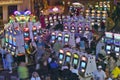 Rows of slot machines and gamblers at Rio Casino in Las Vegas, NV