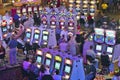 Rows of slot machines and gamblers at Rio Casino in Las Vegas, NV