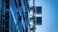 Rows of small rectangular solar panels attached to the side of a sleek communication tower