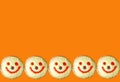 Rows of Smiling Face Coconut Flakes Jelly Donuts on Vivid Orange Background