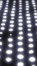 Rows of soft glowing dots forming a bright futuristic surface with subtle depth and smooth light blur Royalty Free Stock Photo