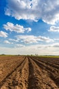 Rows of soil before planting. Furrows row pattern in a plowed field prepared for planting crops in spring. view of land prepared f