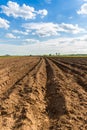 Rows of soil before planting. Furrows row pattern in a plowed field prepared for planting crops in spring. view of land prepared f