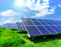 Rows of solar panels installed in green grass field blue sky bright sunlight. Renewable energy sustainable living. AI generated Royalty Free Stock Photo