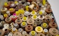 Rows of spools of thread of different colors in a box in the studio Royalty Free Stock Photo