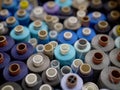 Rows of spools of thread of different colors in a box in the studio Royalty Free Stock Photo