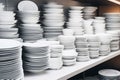 Lots of white plates. Rows and stacks of empty buffet plates on a shelf. Clean dishes