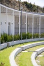 Rows of stairs and grass in the amphitheater. Modern architecture and landscape design in the park.