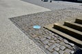 3 rows of stairs in the square are gradually sunk into the paving. Slow transition of the staircase to the plane by blending, inte