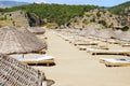 Rows of straw umbrellas on empty seaside beach