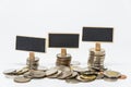 Rows of Thai baht coins and small black board for finance and banking concept with white background and selective focus