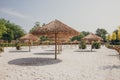 Rows of thatch umbrellas in the park. Royalty Free Stock Photo
