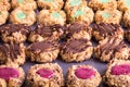 Rows of thumbprint cookies with nuts