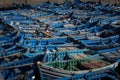 Rows of traditional blue fishing boats in the harbor of the city of Essaouira, in the Atlantic Coast of Morocco