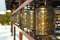 Traditional spinning prayer wheels at temple complex, asian culture of Hindu and Buddhist faith at local monastery