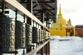 Traditional spinning prayer wheels at temple complex, asian culture of Hindu and Buddhist faith at local monastery