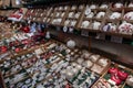 Rows of traditional handcrafted glass Christmas ornaments of various shapes in boxes on shelves at Christmas fair in Berlin German