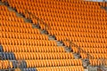 Rows of vacant empty orange fold up seating