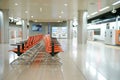 Rows of vacany steel seats for the passengers inside the subway station. Empty platform of the train station Royalty Free Stock Photo