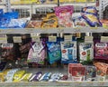 Rows of variety type and brand of candy product on shelves in a minimarket