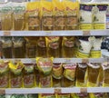 Rows of variety type and brand of cooking oil product on shelves in a minimarket.Palm oil and coconut oil