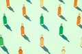 Rows of various color glass bottles against light blue green surface Royalty Free Stock Photo