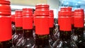Rows of vine bottles with red stoppers on the shop window Royalty Free Stock Photo
