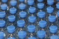 Rows of water bottles with blue caps. View from above Royalty Free Stock Photo