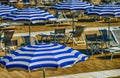 Rows of white and blue beach umbrellas Royalty Free Stock Photo