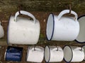 2 rows of white and blue enamel mugs