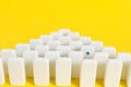 Rows white domino chips with one eye catching, concept is individual and not like everyone else