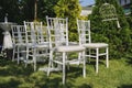 Rows of white empty chairs on a lawn before a wedding ceremony Royalty Free Stock Photo