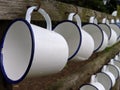2 rows of white enamel mugs Royalty Free Stock Photo