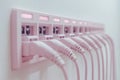 Rows of white Ethernet cables plugged into a white network hub illustrating seamless internet connectivity and structured cabli
