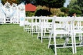 Rows of white folding chairs on lawn Royalty Free Stock Photo