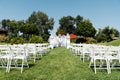 Rows of white folding chairs on lawn Royalty Free Stock Photo